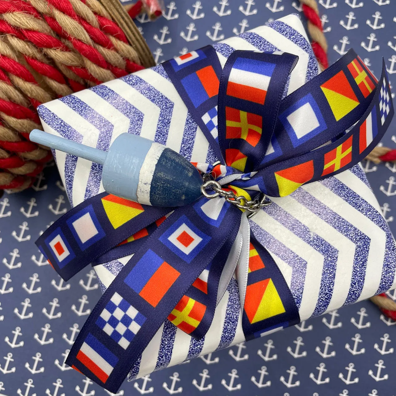 Nautical Flag ribbon flags spell NEWPORT with a navy blue background printed on  7/8" white satin and grosgrain